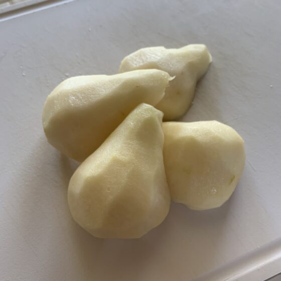 Photograph of two cleaned, cored, peeled and halved bosc pears.
