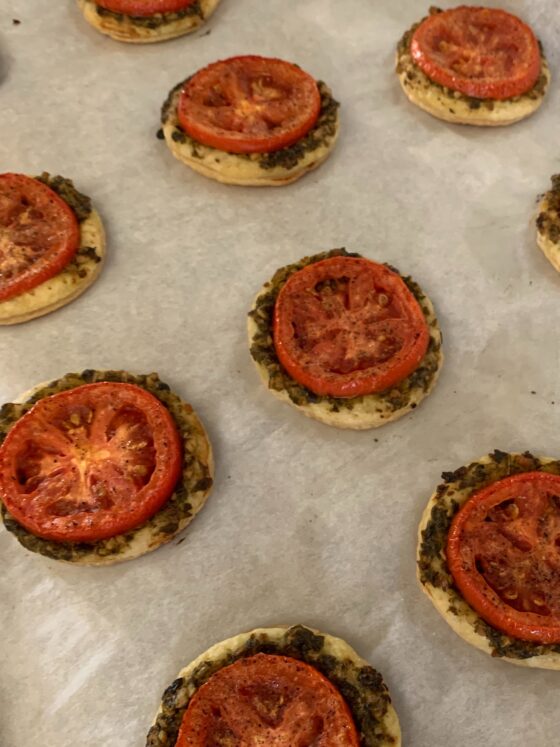 Parchment paper lined cookie tray with roasted Tomato Puffs
