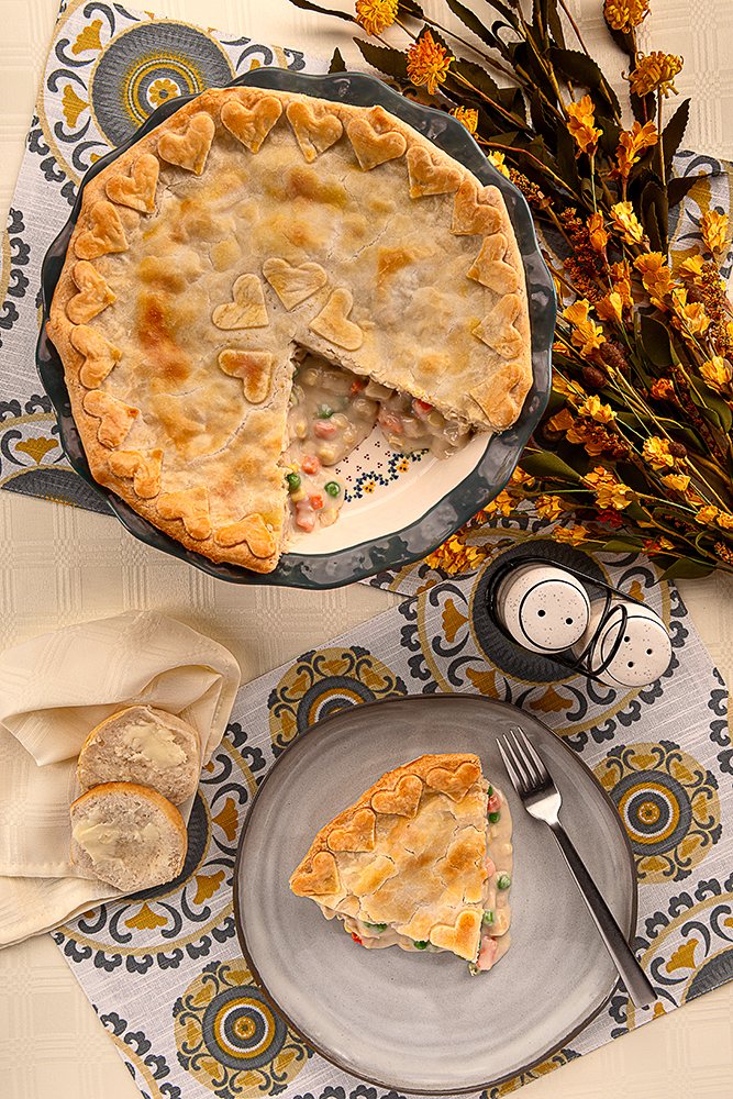 A serving of chicken pot pie and a pie plate with chicken pot pie