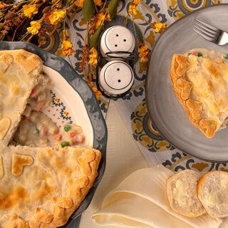 A serving of chicken pot pie and a pie plate with chicken pot pie